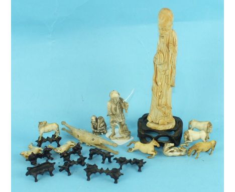 A Chinese ivory figure of a standing Immortal, 19cm high, two Japanese bone figures and a miniature set of The Eight Horses o