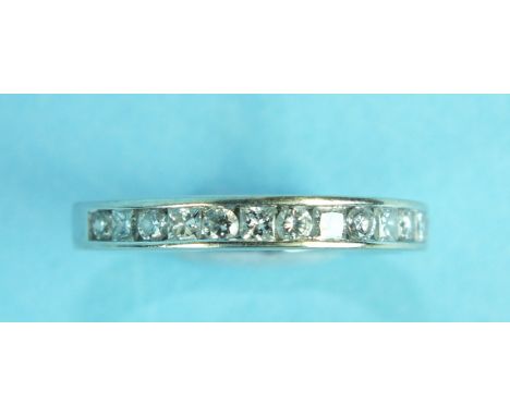 A half-eternity ring channel-set thirteen alternate brilliant and princess-cut diamonds, in 18ct white gold mount, size L, 3.