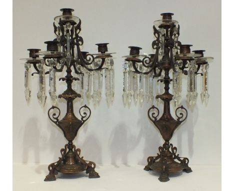 A pair of early-20th century copper finish metal five-light candelabra adorned with cut glass drops, 48cm high, (2).