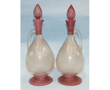 A pair of 19th century clear glass decanters and stoppers engraved with hunting scenes of dogs, game birds and a rabbit, the 