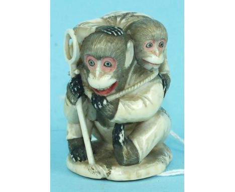 An ivory group of two monkeys playing, signed.