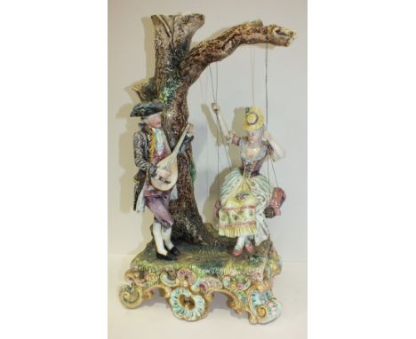 A large 19th century Royal Dux Bohemia porcelain group of a gallant playing a lute to his companion on a swing, unmarked, sli