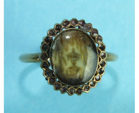 A George III mourning ring with oval ivory glazed panel depicting an urn below a weeping willow, within a paste border, on un