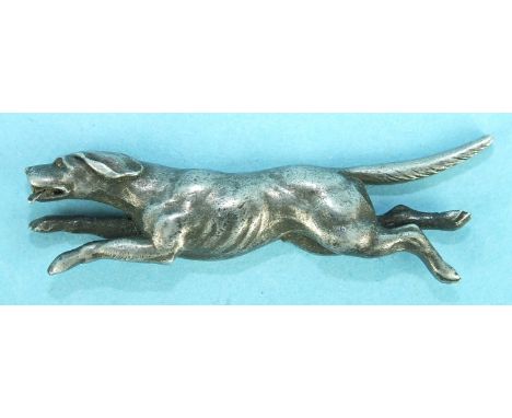 A white metal half-model of a running hound, 45mm long and two metal models of standing hounds, (3).