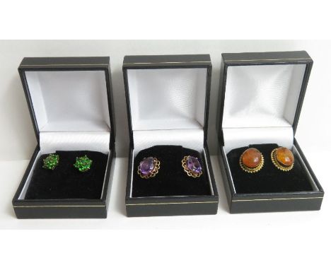 Three pairs of stud earrings to include a pair of 9ct gold green stone clusters, a pair of amethyst single stones and a pair 