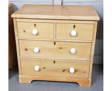 A Victorian pine chest of drawers, with white ceramic handles two long and two short drawers, 80cm high, 83cm long, 43cm deep