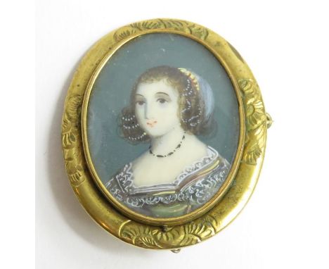 An oval brooch 4cm x 3.5cm, set with a portrait miniature on porcelain of a lady in late in 17th century dress, tests as appr