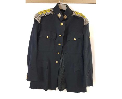 A collection of military uniforms to include a black jacket with Scot Guards badges, mess uniform and an Army jacket and trou