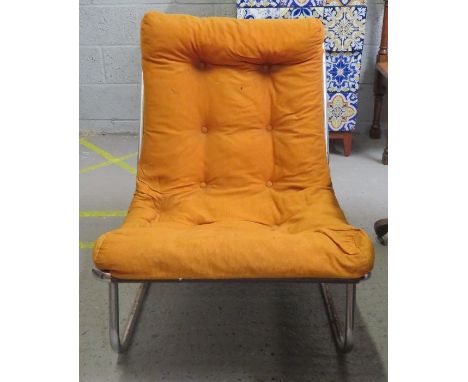 A mid century/vintage chair, standing on a chrome base, upholstered in an orange fabric 