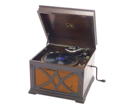 A HMV table top gramophone, in an oak case, the hinged lid enclosing a part chrome fitted interior above a fabric backed spea
