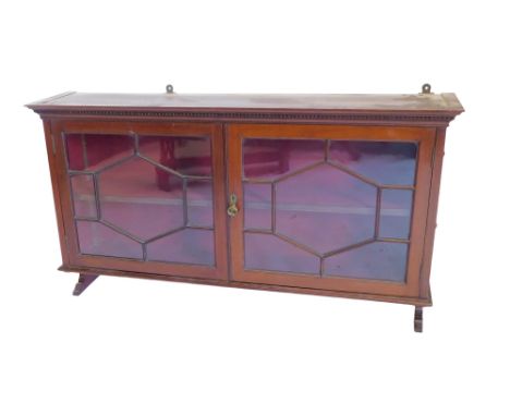 An Edwardian mahogany wall cabinet, the top with a dental cornice, with two astragal glazed doors, including a shelf, on end 