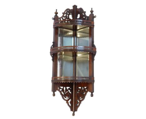A late 19th/early 20thC corner display shelf, with pierced top and bottom, three galleried shelves, each with a bevelled mirr