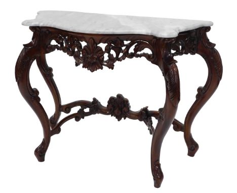 A hardwood console table, the shaped white marble top with a moulded edge, the base with a pierced scroll carved frieze, cabr