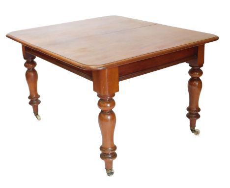 A Victorian mahogany extending dining table, the rectangular top with a moulded edge, on turned legs with ceramic castors, la