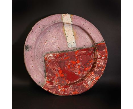 ▴ Robin Welch (1938-2019),a large stoneware charger with a broad edge, an incised pink ground, with a red drip glaze, impress