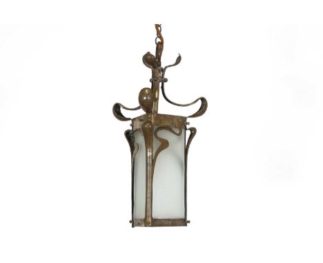 An Arts and Crafts brass hanging lantern,with scrolled supports, a triform panelled mount, frosted glass shades and a chain s