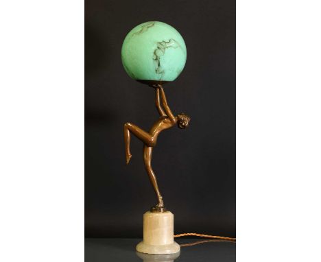 An Art Deco figural table lamp,by Josef Lorenzl, modelled as a nude holding a mottled-jade-green globe, on an onyx plinth,52c