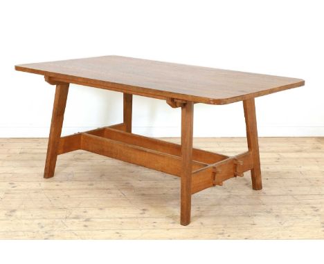 A Cotswold oak refectory table, 1970s, with tapering and chamfered supports, united with a double-pegged stretcher, stamped '