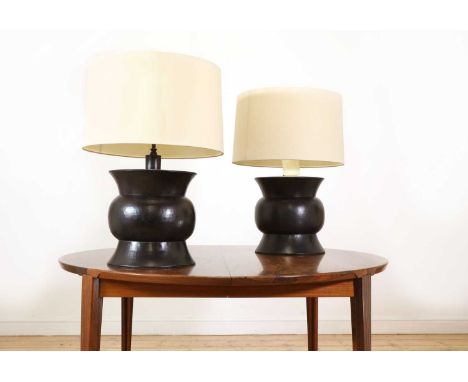A pair of modern lamps, by McGuire, each with a hammered metal base, stamped 'M', each mounted with two lights and with a lin