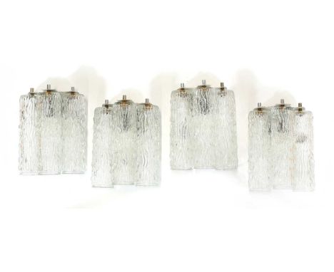 A set of four textured 'bark' glass wall lights, 1970s, each with three glass cylindrical shades and fitted with a light, 15c