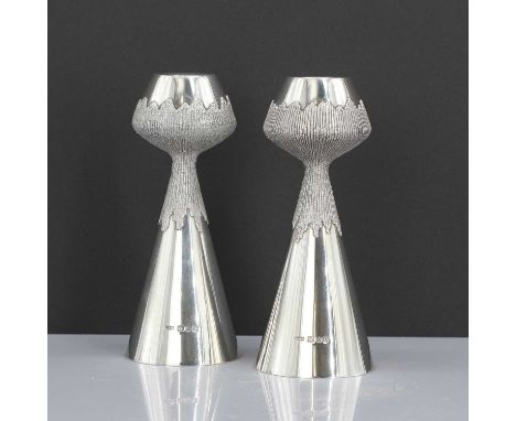 A pair of silver candlesticks, by Grant MacDonald Silversmiths, London 1976,each tapering candlestick with a tulip form sconc