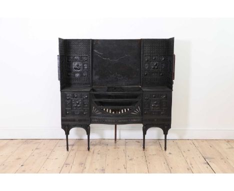 An Aesthetic Coalbrookdale cast iron fireplace,c.1880, in the manner of Thomas Jeckyll, with a central bow-front grate, with 