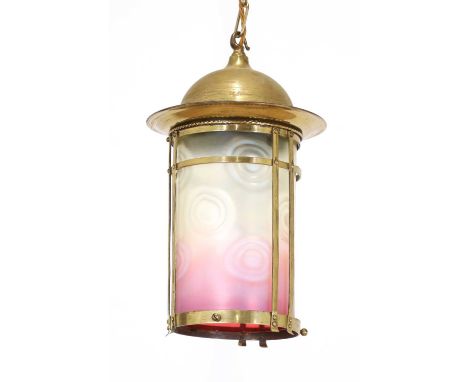 An Arts and Crafts vaseline glass hanging lantern, the brass dome top with a cage, the cylindrical opaline glass shade mergin