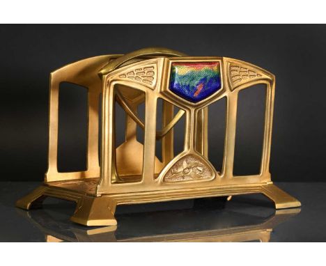 An Arts and Crafts cast metal letter rack,c.1900, with two divisions, and with a coloured enamel mount to each side, 18cm wid