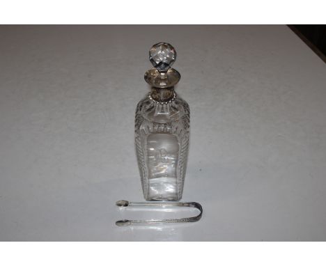A cut glass and silver necked decanter and stopper and a pair of silver bright cut sugar tongs 