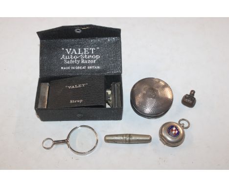 A box containing a silver compact; an enamel decorated sovereign case; a fob seal; magnifying glass and a Autostrop razor