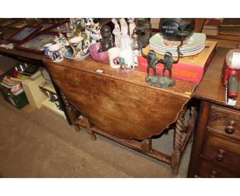 An oak gate leg, barley twist drop leaf table 