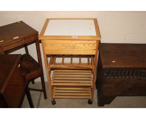 A tile top kitchen trolley