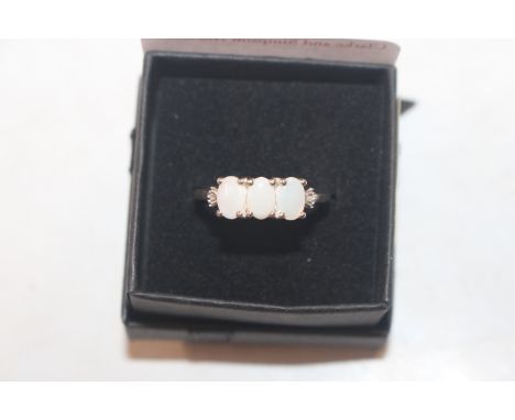 A Sterling silver and opal three stone ring, ring size N.O