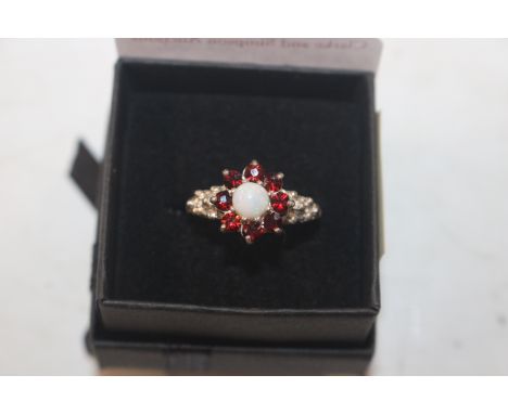 A vintage Sterling silver garnet and opal halo ring, ring size N/O