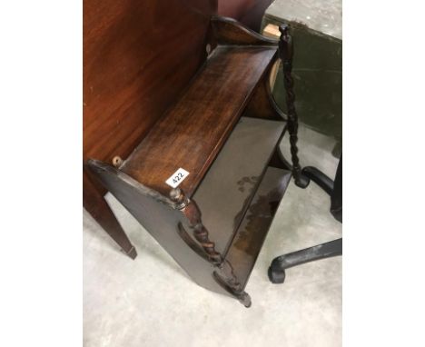 A 1930s oak wall shelf