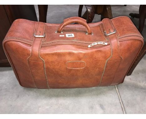 A light brown leather suitcase