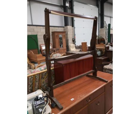 A dark wood free standing tapestry stand