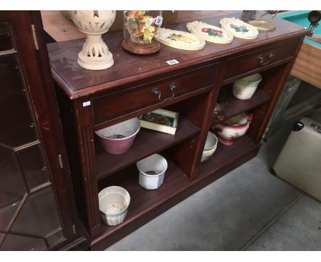 A mahogany veneered two shelf book shelf