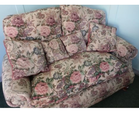 Victorian style two seat sofa with rolled arms and tapestry upholstery on turned wooden supports (width 150cm) 