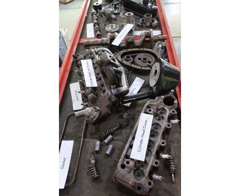 Mounted museum type display of an early BMC A Series engine component, broken down, comprising of various parts in a dispaly 
