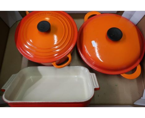 A burnt orange color le cruset shallow twin handled pan and lid and another large pan and a casserole type dish (3) 