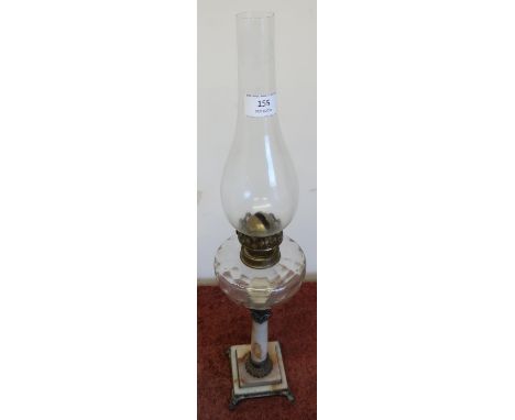 Oil lamp with molded clear glass reservoir on carynthum marble column and stepped square base (height 60cm including chimney)