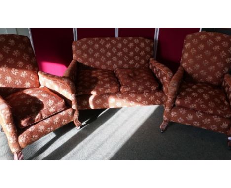 Circa 1930s three piece suite, comprising of two seat sofa and a pair of matching armchairs, on carved mahogany supports 