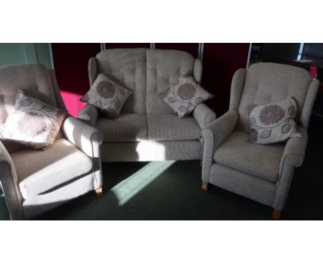 Modern three piece suite in oatmeal fabric comprising of two seat sofa and pair of matching armchairs, on light wood supports