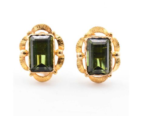 A pair of 9ct gold and green tourmaline earrings. The earrings having a step-cut tourmaline to scalloped mount with screw-bac