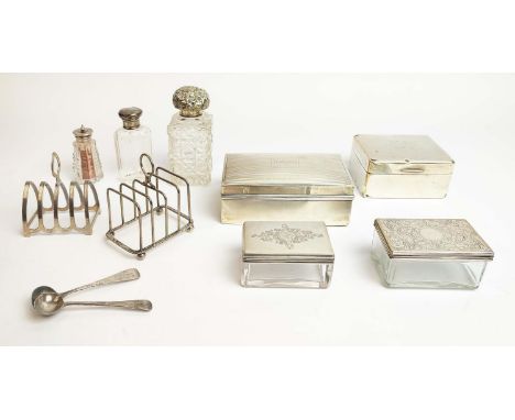 A COLLECTION OF SILVERWARE, comprising two cigarette boxes, two silver topped glass boxes, two toast racks, scent bottles, a 