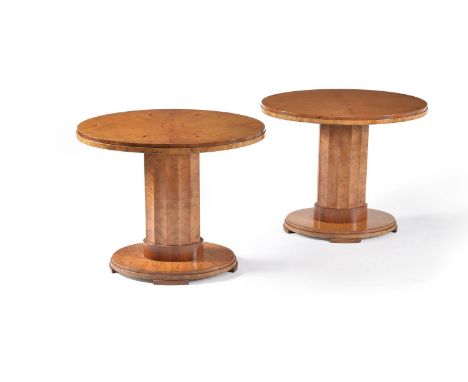 A pair of Art Deco walnut veneered oval occasional tables, circa 1930, each with oval top above a fluted facetted pillar oval