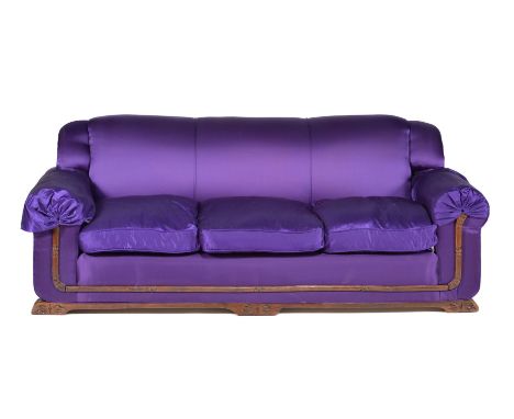 An Art Deco three-seater sofa, upholstered in bright amethyst silk, stained beech rails, 80cm high, 217cm wide, 79cm deep    