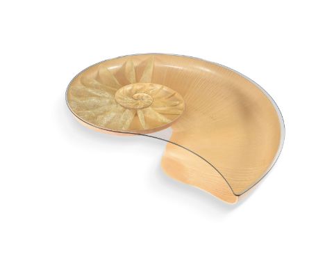 Marc Fish, a Nautilus table, signed, dated 2011, 1 of 2, the carved sycamore shell form top with Japanese paper segments on m