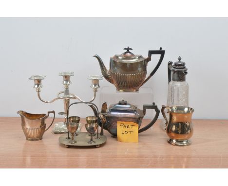 A large collection of silver plate and other metal items, including a teapot, milk jug, metal topped decanter, tureens and co